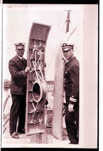 Image of Two naval men holding parts of airplane wings